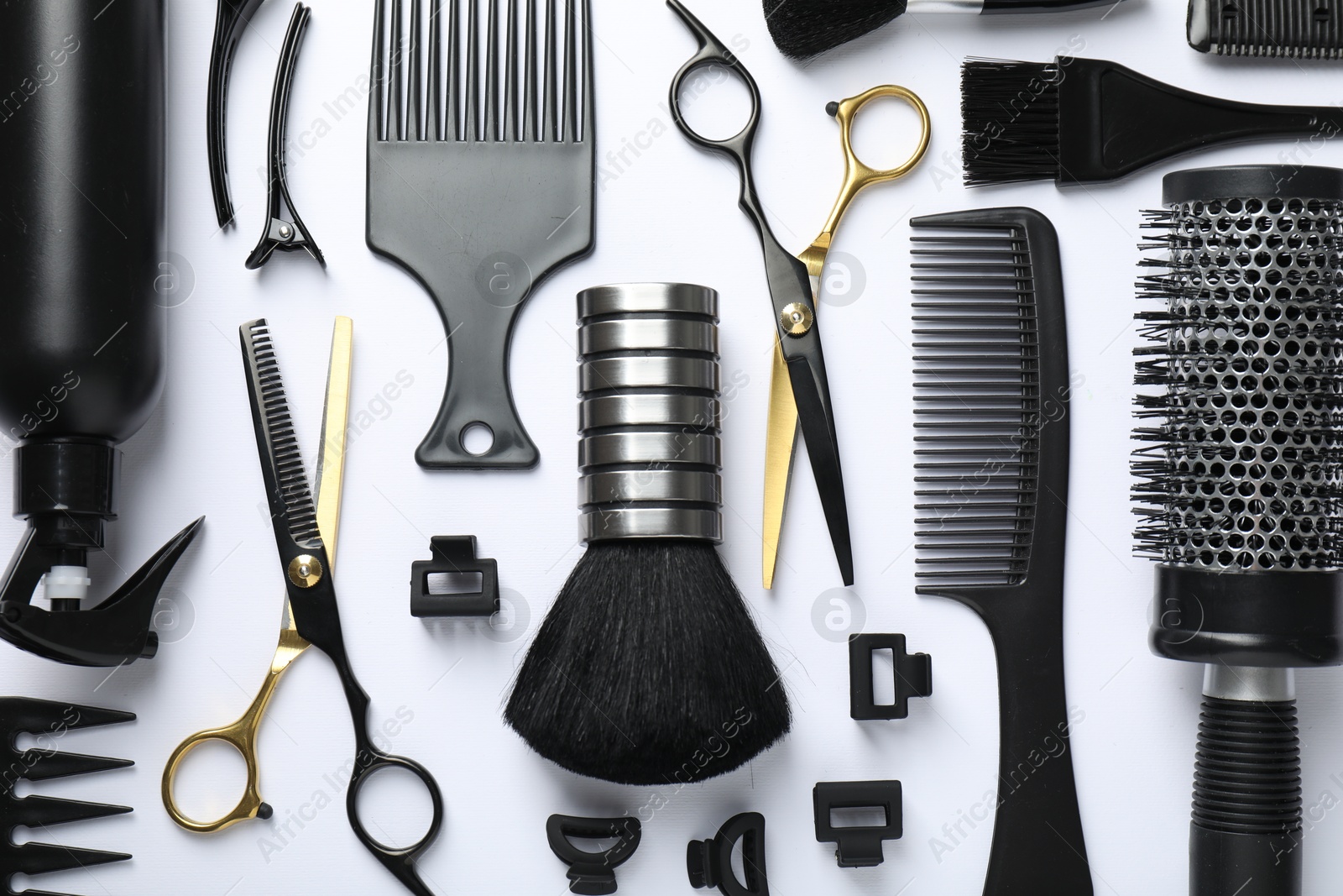 Different hairdresser's tools on white background, flat lay Photo of Different hairdresser's tools on white background, flat lay