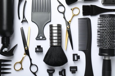 Photo of Different hairdresser's tools on white background, flat lay