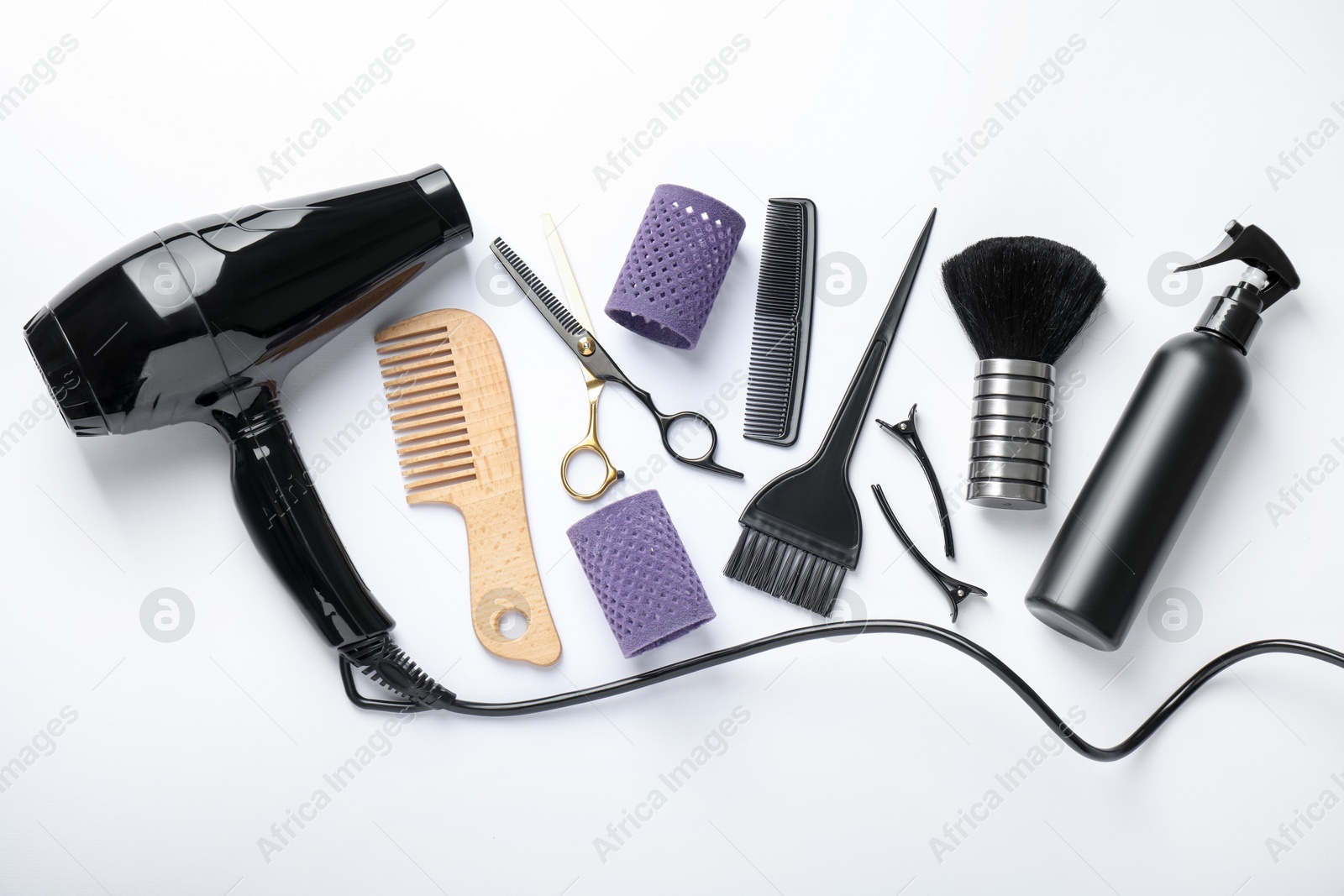 Different hairdresser's tools on white background, flat lay Photo of Different hairdresser's tools on white background, flat lay