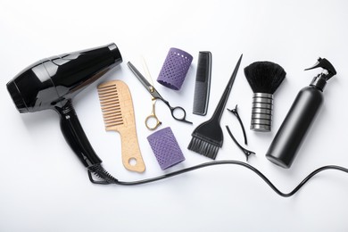Photo of Different hairdresser's tools on white background, flat lay