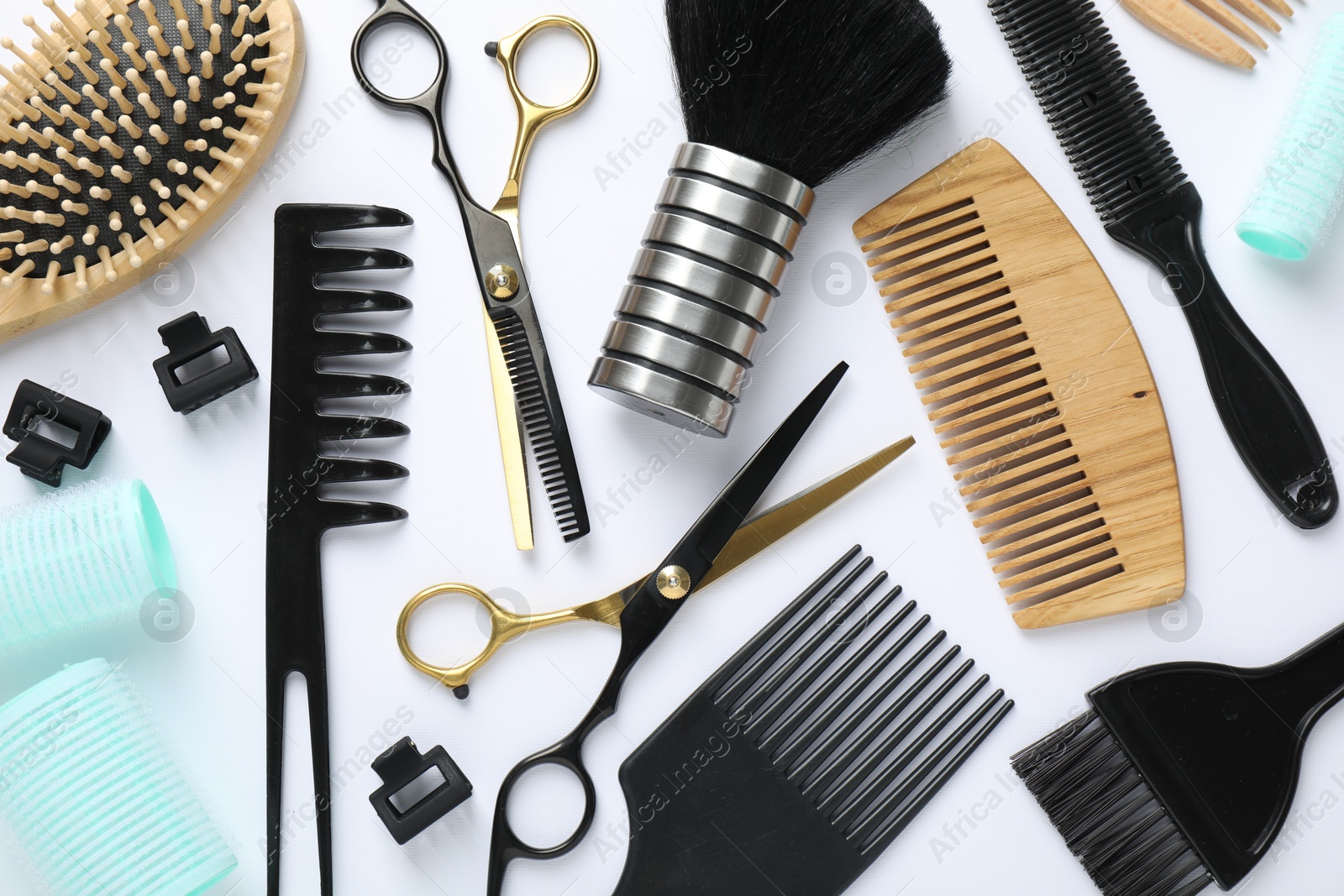 Different hairdresser's tools on white background, flat lay Photo of Different hairdresser's tools on white background, flat lay