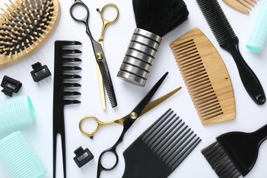 Photo of Different hairdresser's tools on white background, flat lay