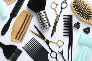 Photo of Different hairdresser's tools on white background, flat lay