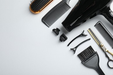 Photo of Different hairdresser's tools on white background, flat lay. Space for text