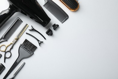 Photo of Different hairdresser's tools on white background, flat lay. Space for text