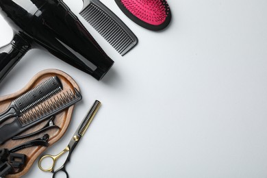 Photo of Different hairdresser's tools on white background, flat lay. Space for text