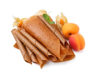 Photo of Delicious fruit leather rolls, mint, apricots and physalis isolated on white