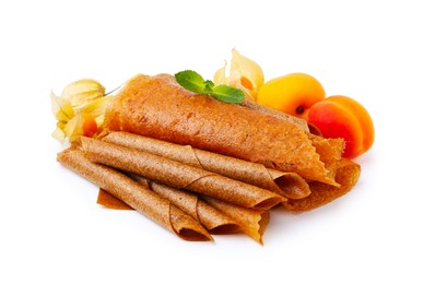 Photo of Delicious fruit leather rolls, mint, apricots and physalis isolated on white