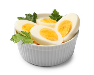 Photo of Boiled eggs and parsley in bowl on white background