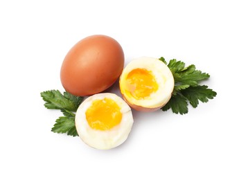Photo of Soft boiled eggs and parsley on white background, top view