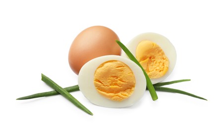 Photo of Hard boiled eggs with green onions isolated on white