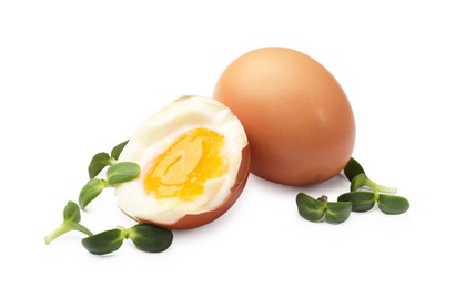 Photo of Soft boiled eggs with microgreens on white background
