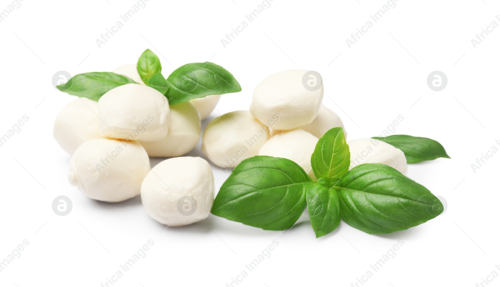 Tasty mozzarella cheese balls and basil isolated on white Photo of Tasty mozzarella cheese balls and basil isolated on white