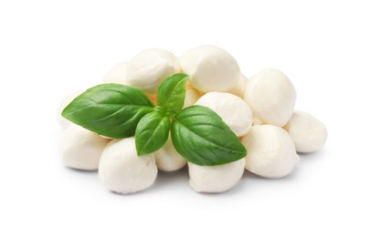 Photo of Tasty mozzarella cheese balls and basil isolated on white