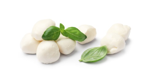 Photo of Tasty mozzarella cheese balls and basil isolated on white