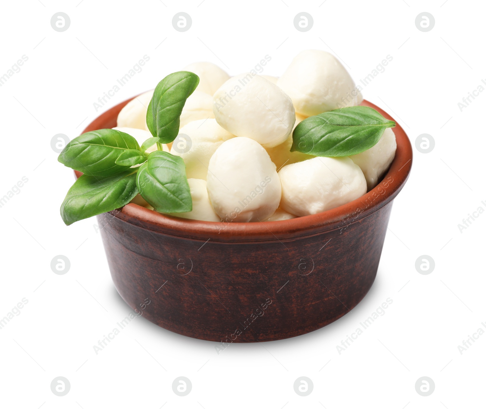 Tasty mozzarella cheese balls and basil in bowl isolated on white Photo of Tasty mozzarella cheese balls and basil in bowl isolated on white