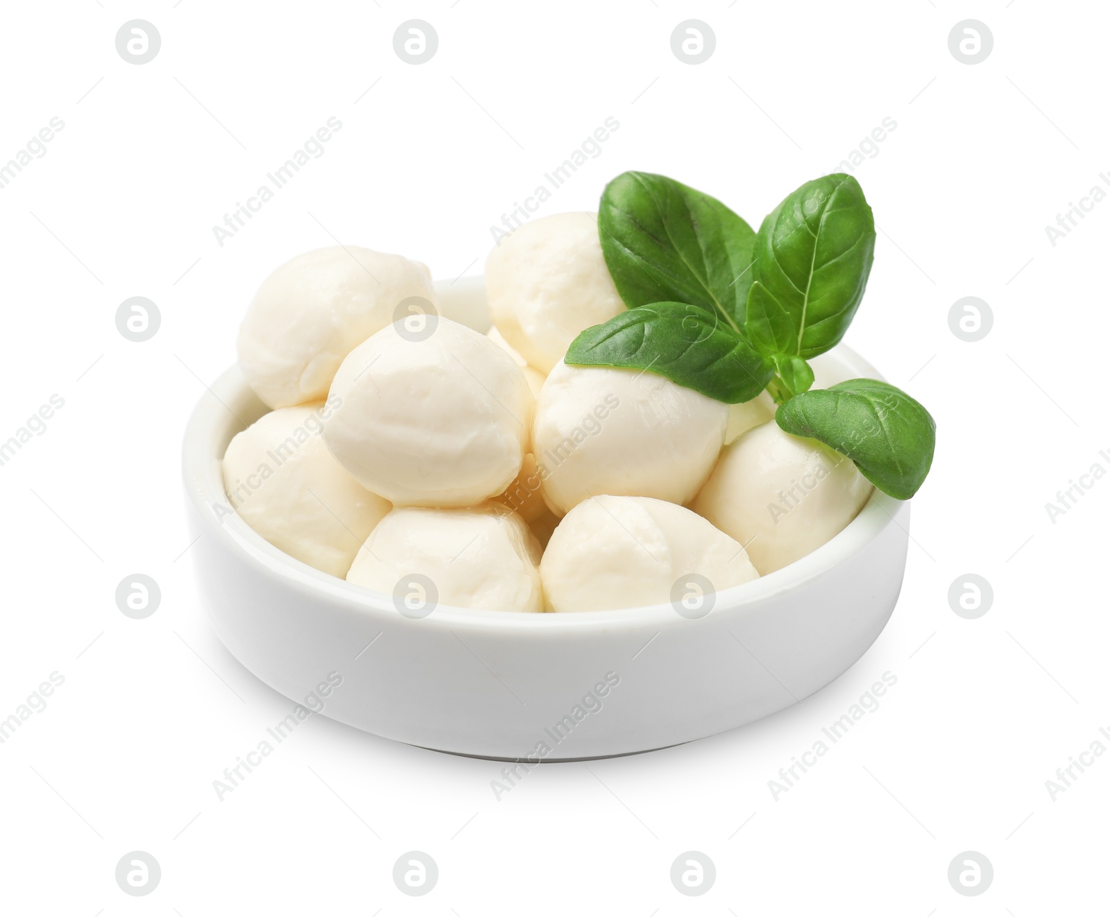 Tasty mozzarella cheese balls and basil in bowl isolated on white Photo of Tasty mozzarella cheese balls and basil in bowl isolated on white