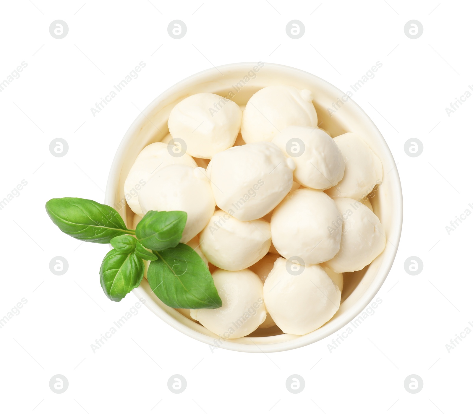 Tasty mozzarella cheese balls and basil in bowl isolated on white, top view Photo of Tasty mozzarella cheese balls and basil in bowl isolated on white, top view