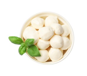 Photo of Tasty mozzarella cheese balls and basil in bowl isolated on white, top view