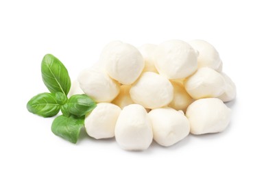 Photo of Tasty mozzarella cheese balls and basil isolated on white