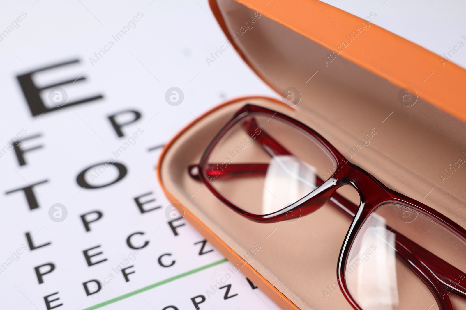Glasses in case on vision test chart, closeup Photo of Glasses in case on vision test chart, closeup