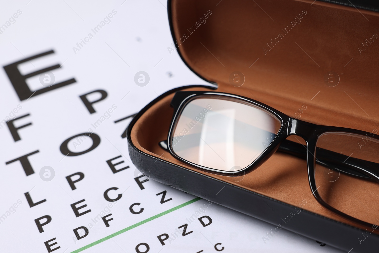Glasses in case on vision test chart, closeup Photo of Glasses in case on vision test chart, closeup