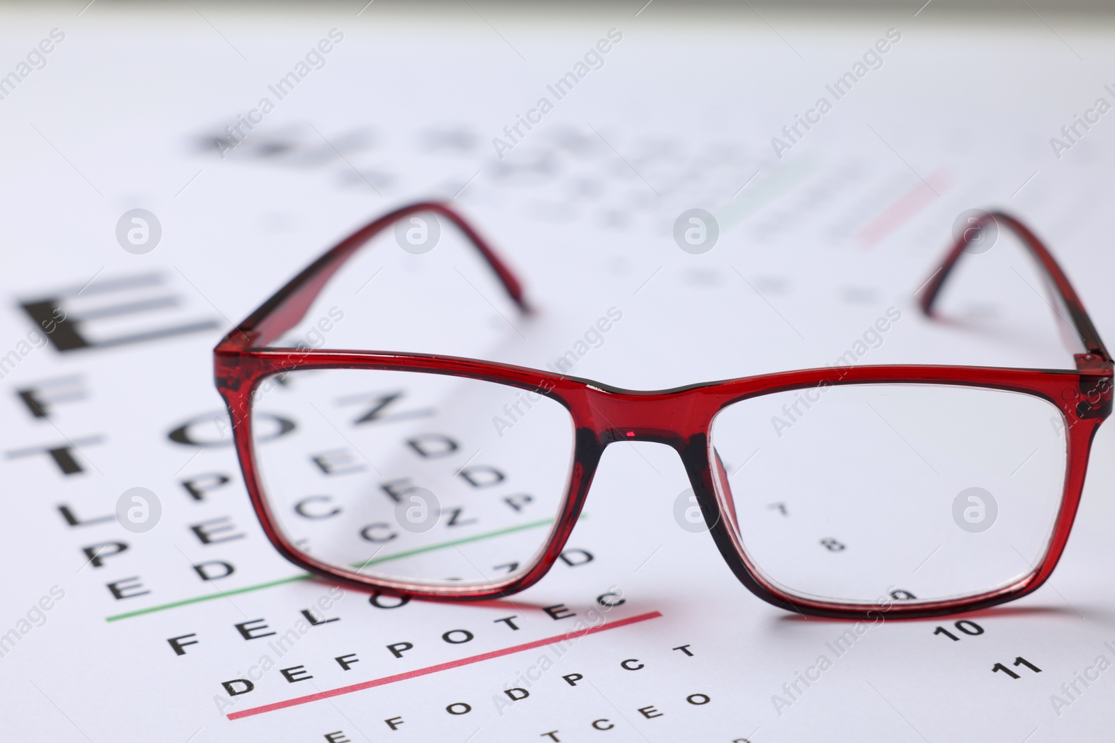 Glasses on vision test charts as background, closeup Photo of Glasses on vision test charts as background, closeup