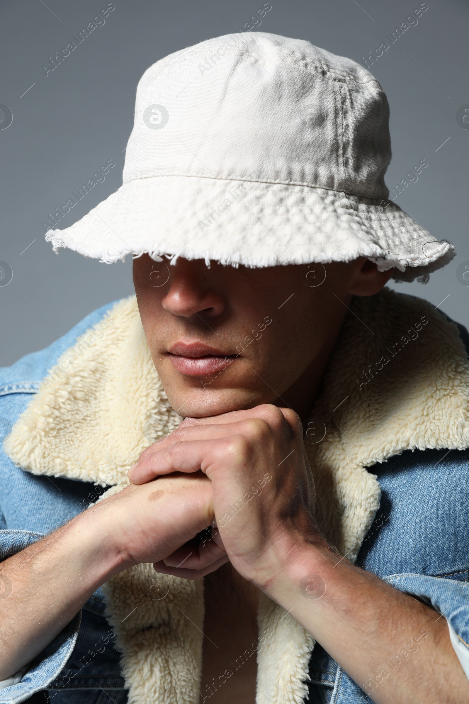 Fashionable portrait of handsome man in stylish outfit on grey background Photo of Fashionable portrait of handsome man in stylish outfit on grey background