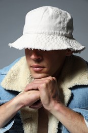 Photo of Fashionable portrait of handsome man in stylish outfit on grey background