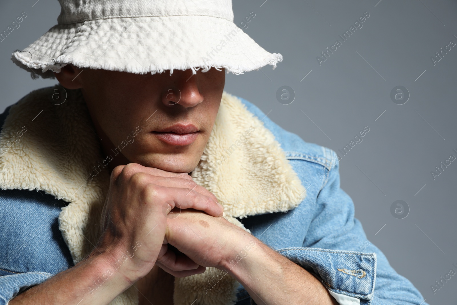 Fashionable portrait of handsome man in stylish outfit on grey background Photo of Fashionable portrait of handsome man in stylish outfit on grey background