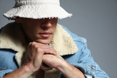 Photo of Fashionable portrait of handsome man in stylish outfit on grey background