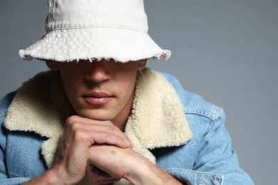 Photo of Fashionable portrait of handsome man in stylish outfit on grey background