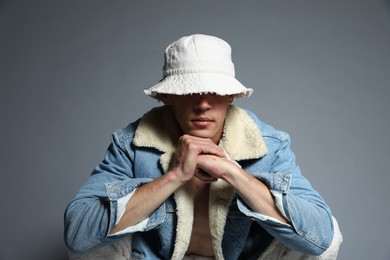Photo of Fashionable portrait of handsome man in stylish outfit on grey background