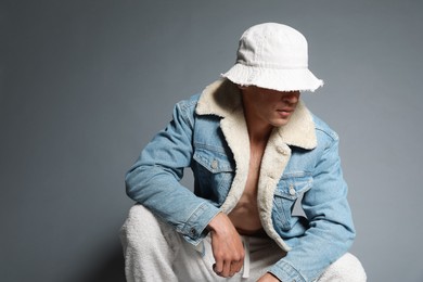 Photo of Fashionable portrait of handsome man in stylish outfit on grey background, space for text