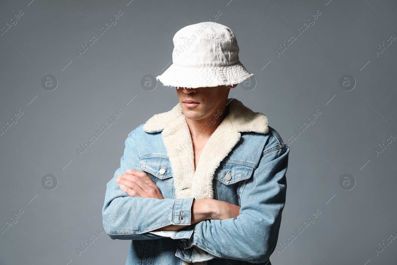 Fashionable portrait of handsome man in stylish outfit on grey background Photo of Fashionable portrait of handsome man in stylish outfit on grey background