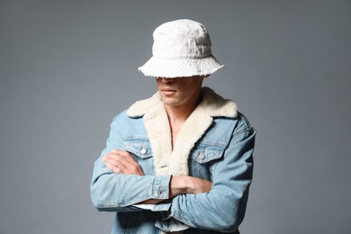 Photo of Fashionable portrait of handsome man in stylish outfit on grey background