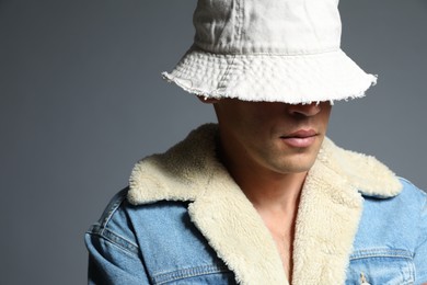 Photo of Fashionable portrait of handsome man in stylish outfit on grey background