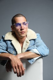 Photo of Fashionable portrait of handsome man in stylish outfit on grey background