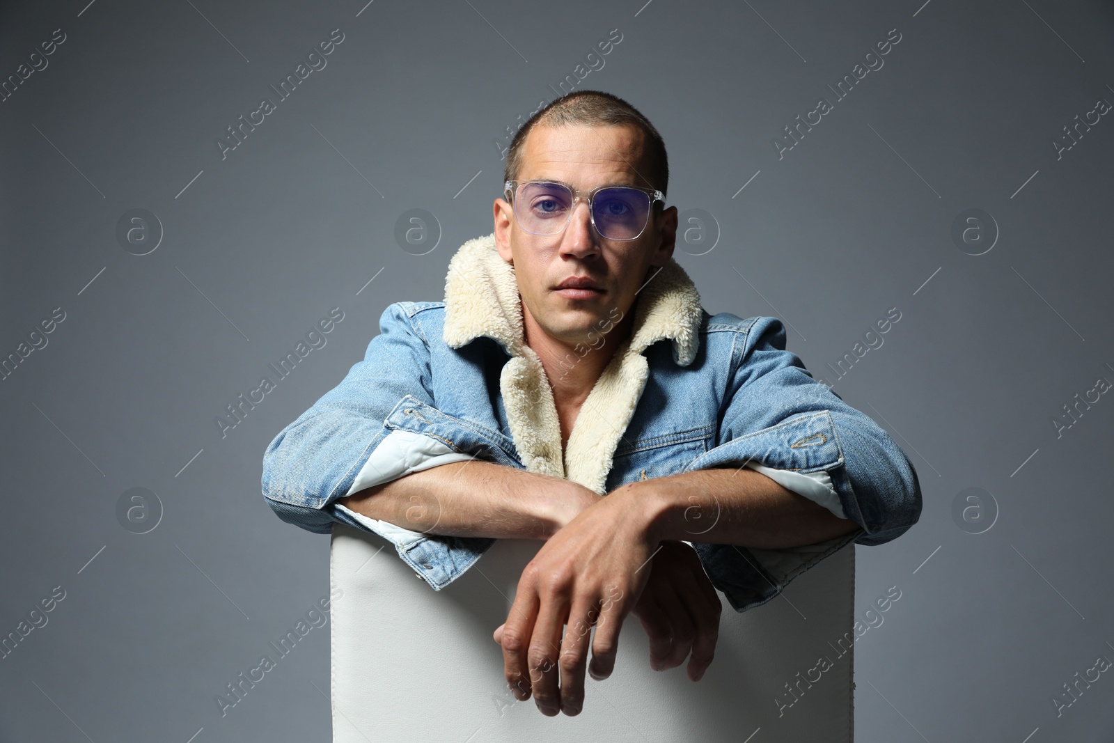 Fashionable portrait of handsome man in stylish outfit on grey background Photo of Fashionable portrait of handsome man in stylish outfit on grey background