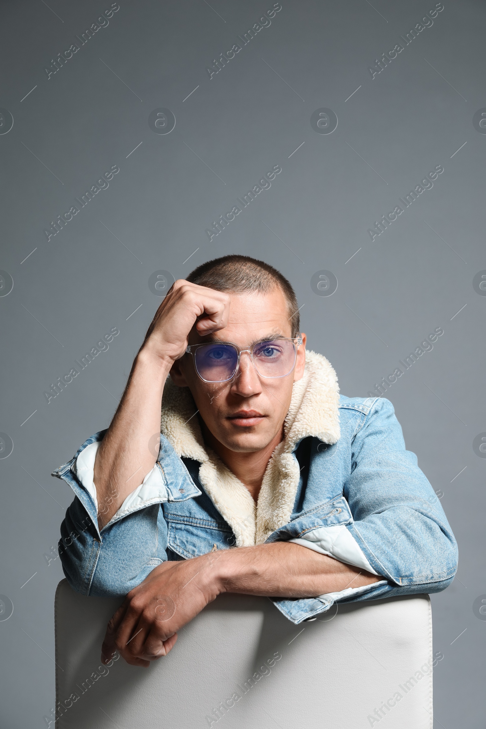 Fashionable portrait of handsome man in stylish outfit on grey background Photo of Fashionable portrait of handsome man in stylish outfit on grey background