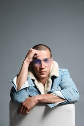 Photo of Fashionable portrait of handsome man in stylish outfit on grey background