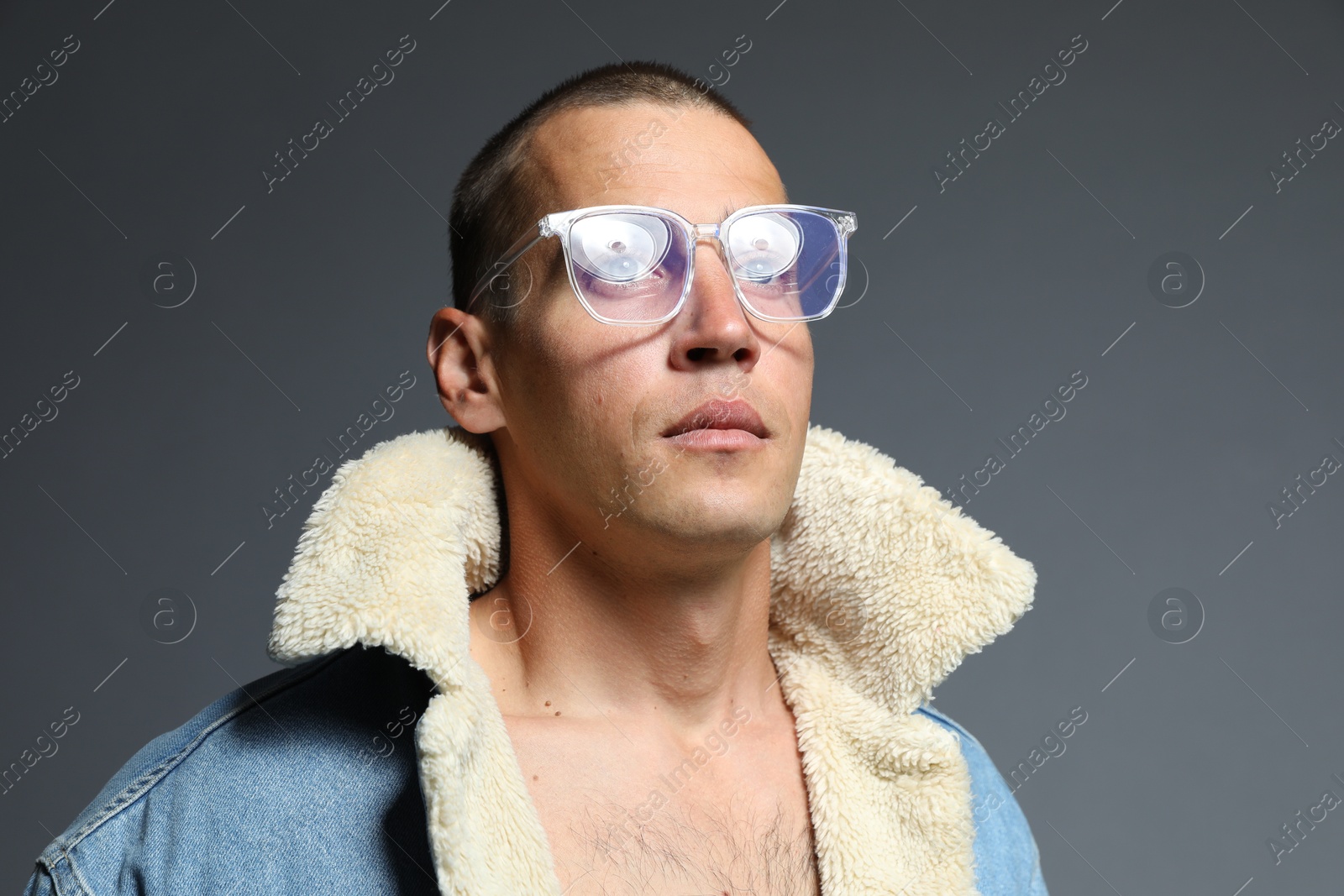 Fashionable portrait of handsome man in stylish outfit on grey background Photo of Fashionable portrait of handsome man in stylish outfit on grey background