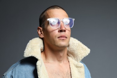 Photo of Fashionable portrait of handsome man in stylish outfit on grey background