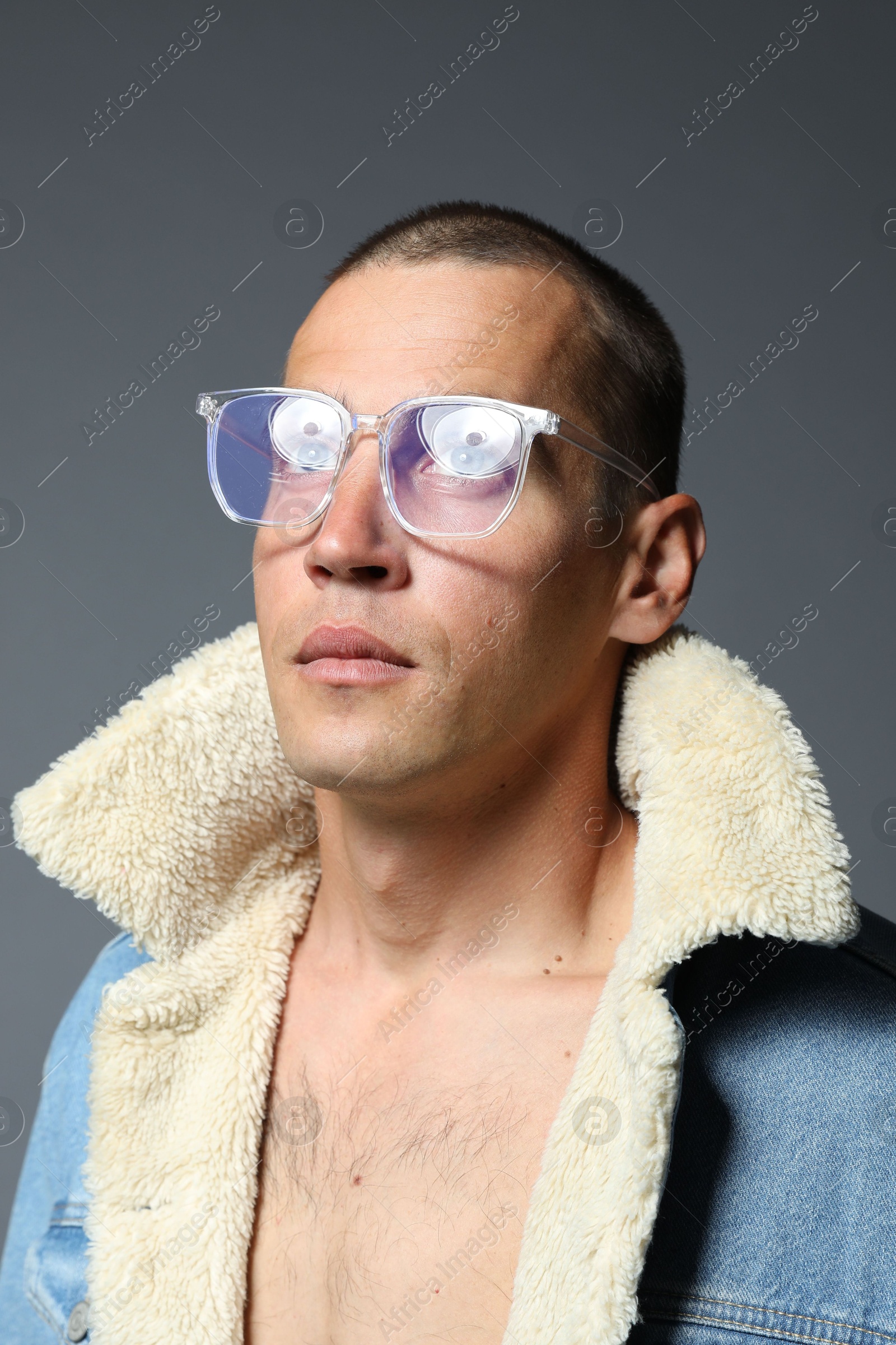 Fashionable portrait of handsome man in stylish outfit on grey background Photo of Fashionable portrait of handsome man in stylish outfit on grey background