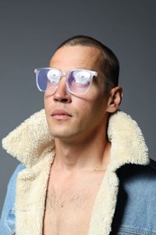 Photo of Fashionable portrait of handsome man in stylish outfit on grey background