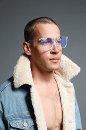 Photo of Fashionable portrait of handsome man in stylish outfit on grey background
