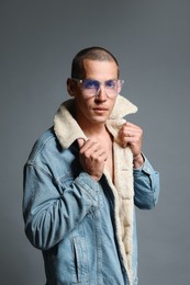 Photo of Fashionable portrait of handsome man in stylish outfit on grey background