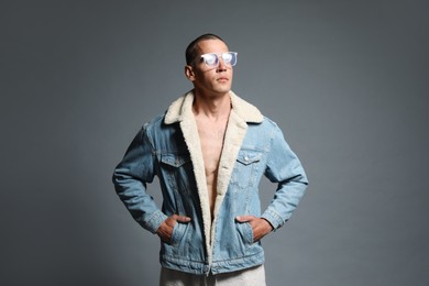Photo of Fashionable portrait of handsome man in stylish outfit on grey background