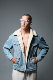 Photo of Fashionable portrait of handsome man in stylish outfit on grey background