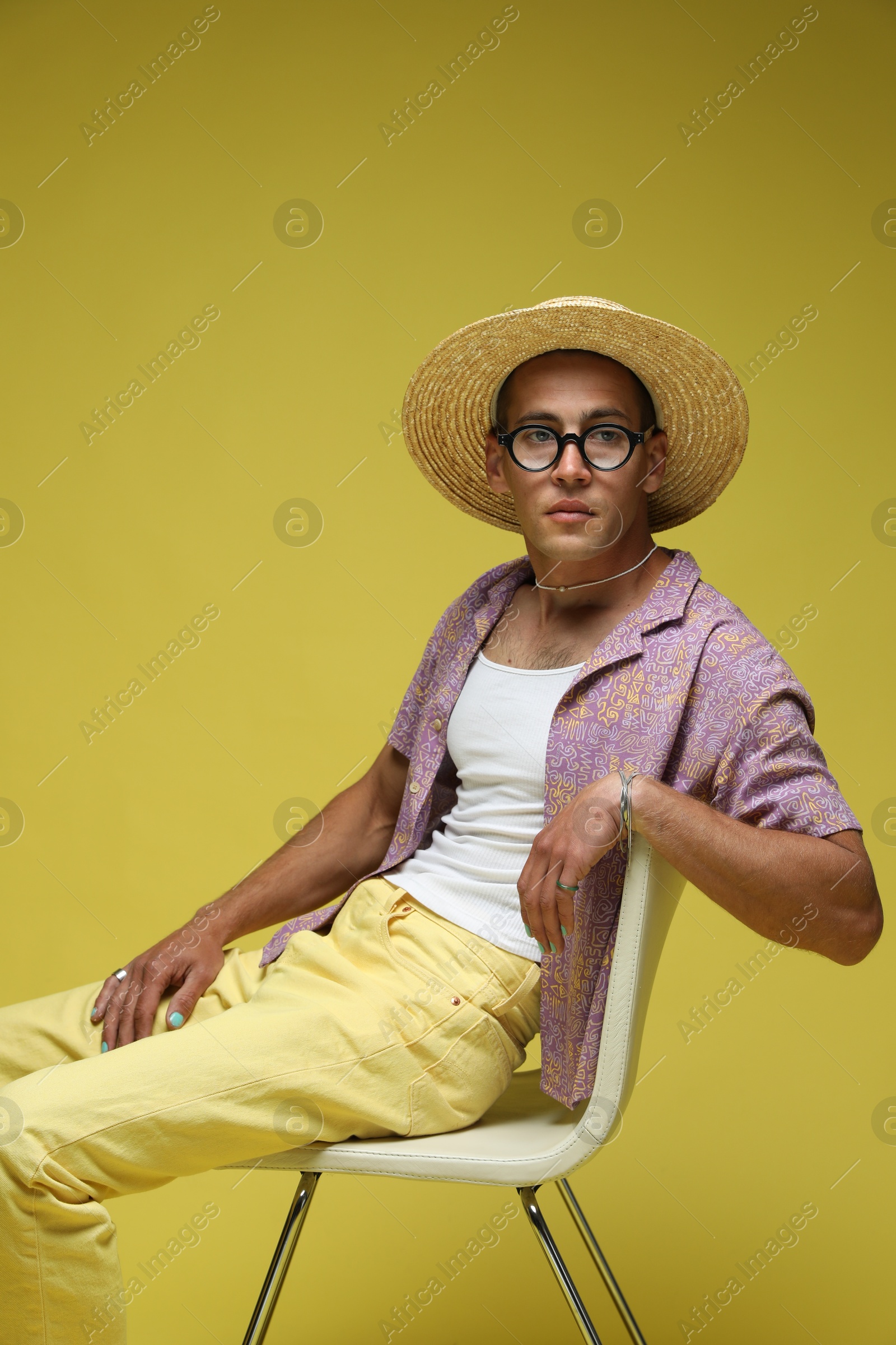 Fashionable portrait of handsome man in stylish outfit on yellow background Photo of Fashionable portrait of handsome man in stylish outfit on yellow background